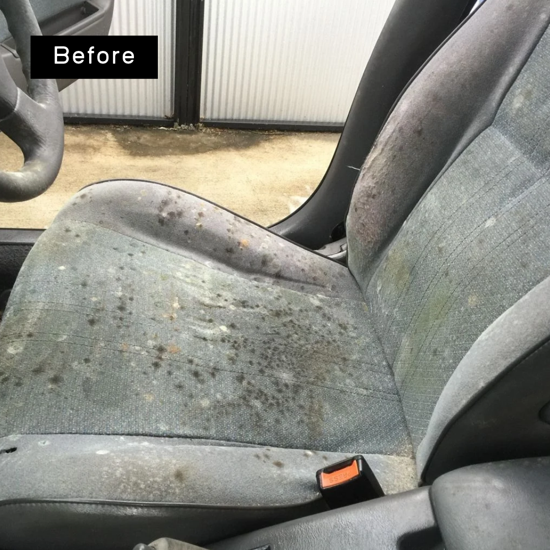 Blue-grey cloth seat with dark mould spotting